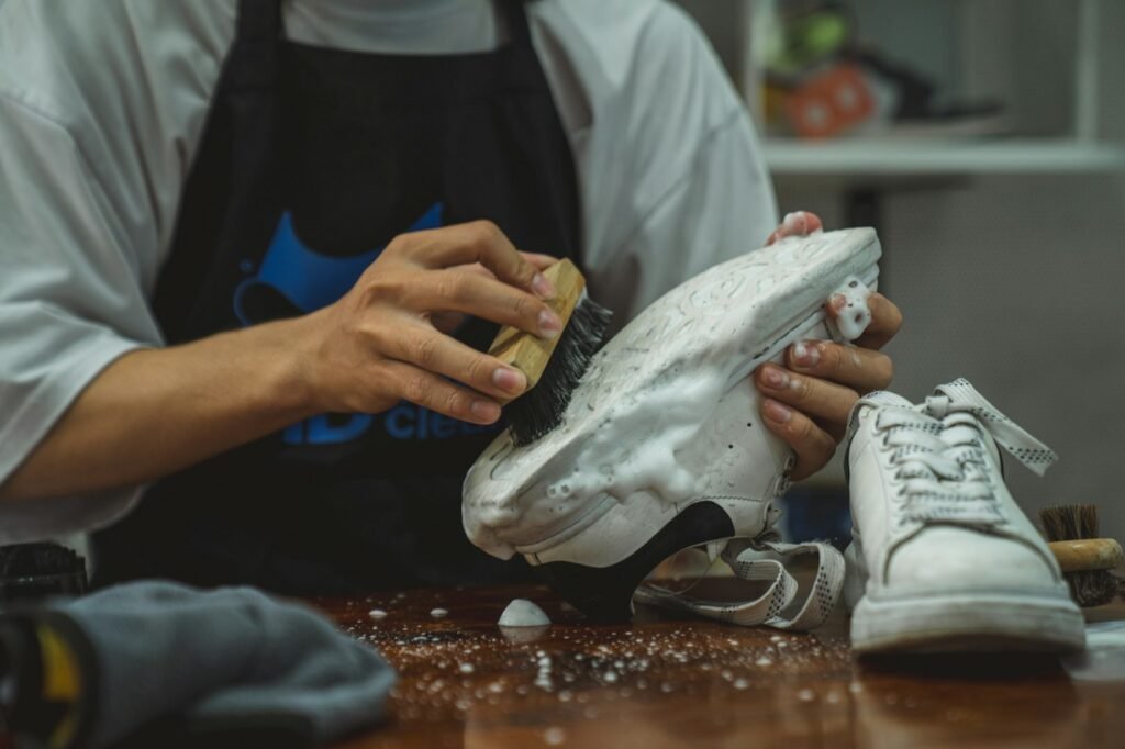 Hands inspecting a pair of shoes